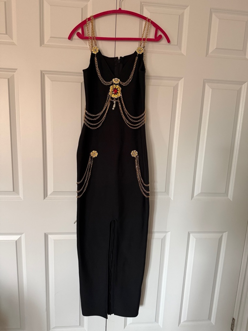 Black Maxi Dress with Gold Chain Accents and Decorative Medallions